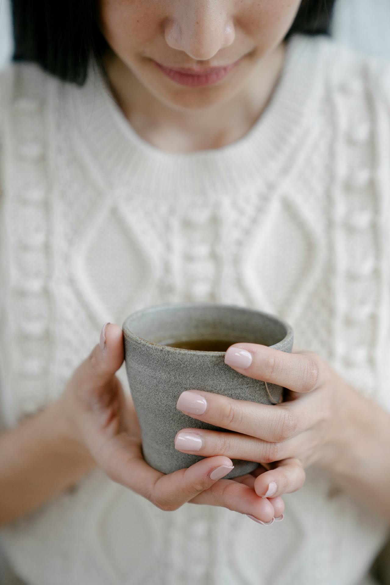 woman holds mug of herbal tea